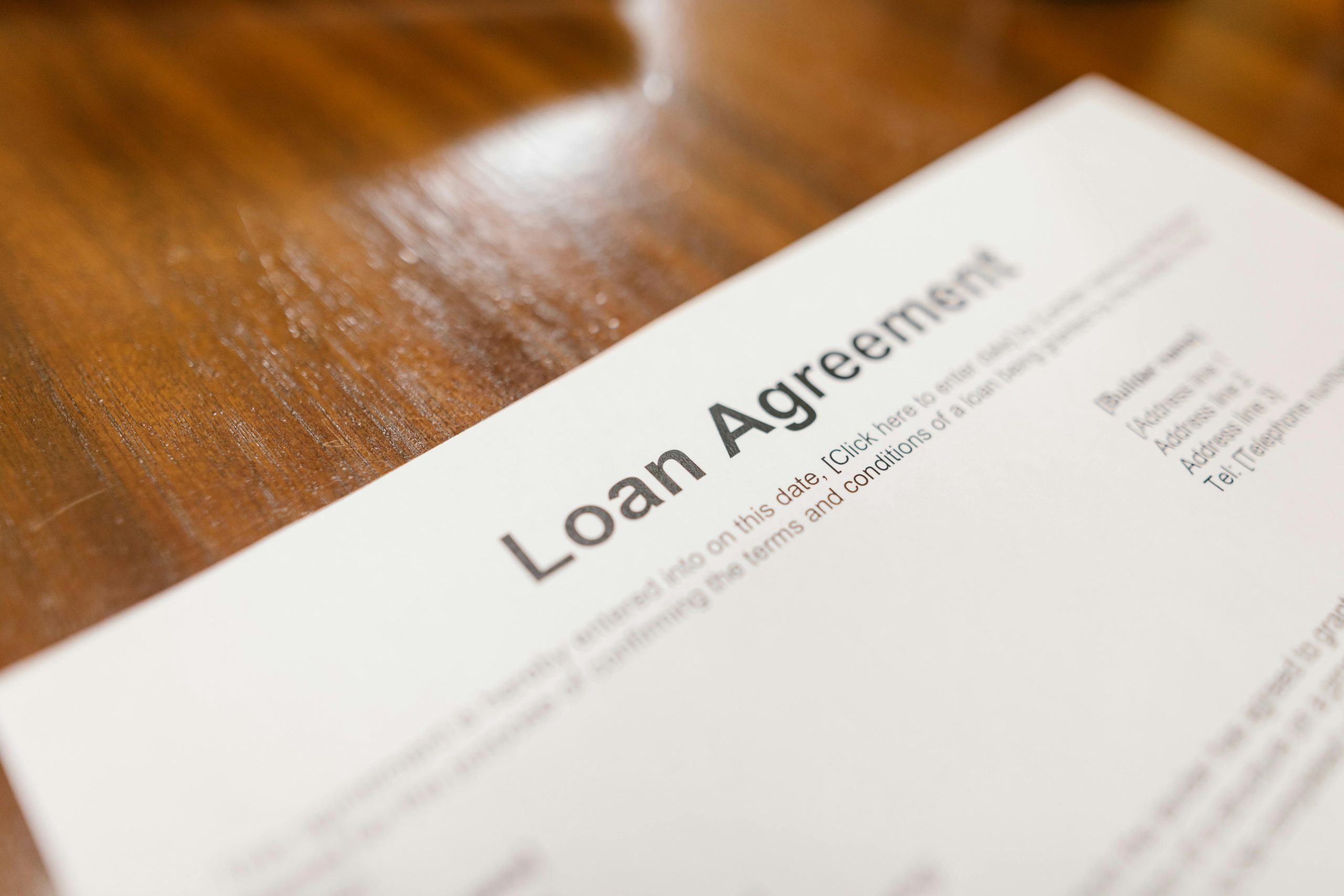 loan agreement document placed on a wooden table